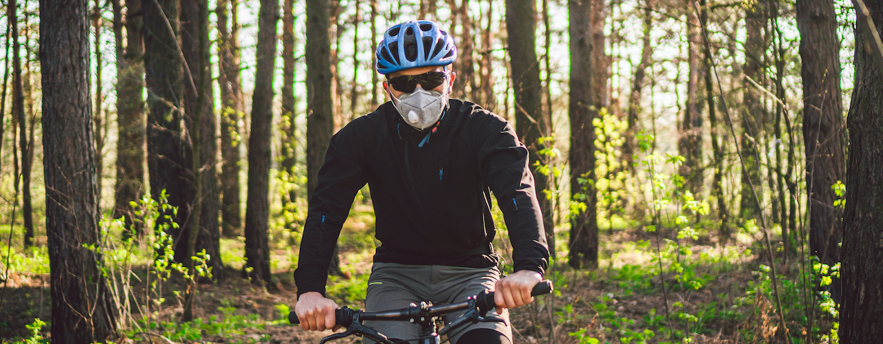 Mountain Biker wearing a helmet and mask