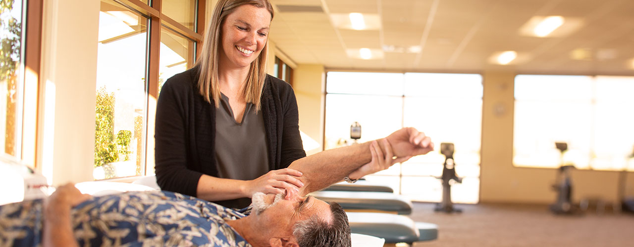 GBO Physical therapist helps patient with range of motion exercises