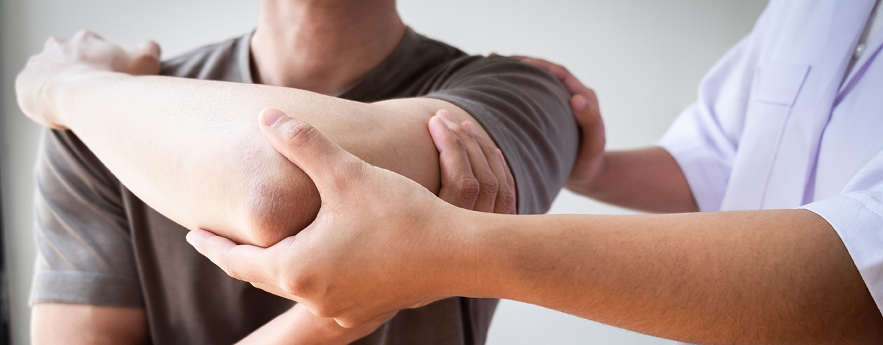 Doctor inspecting rotator cuff injury