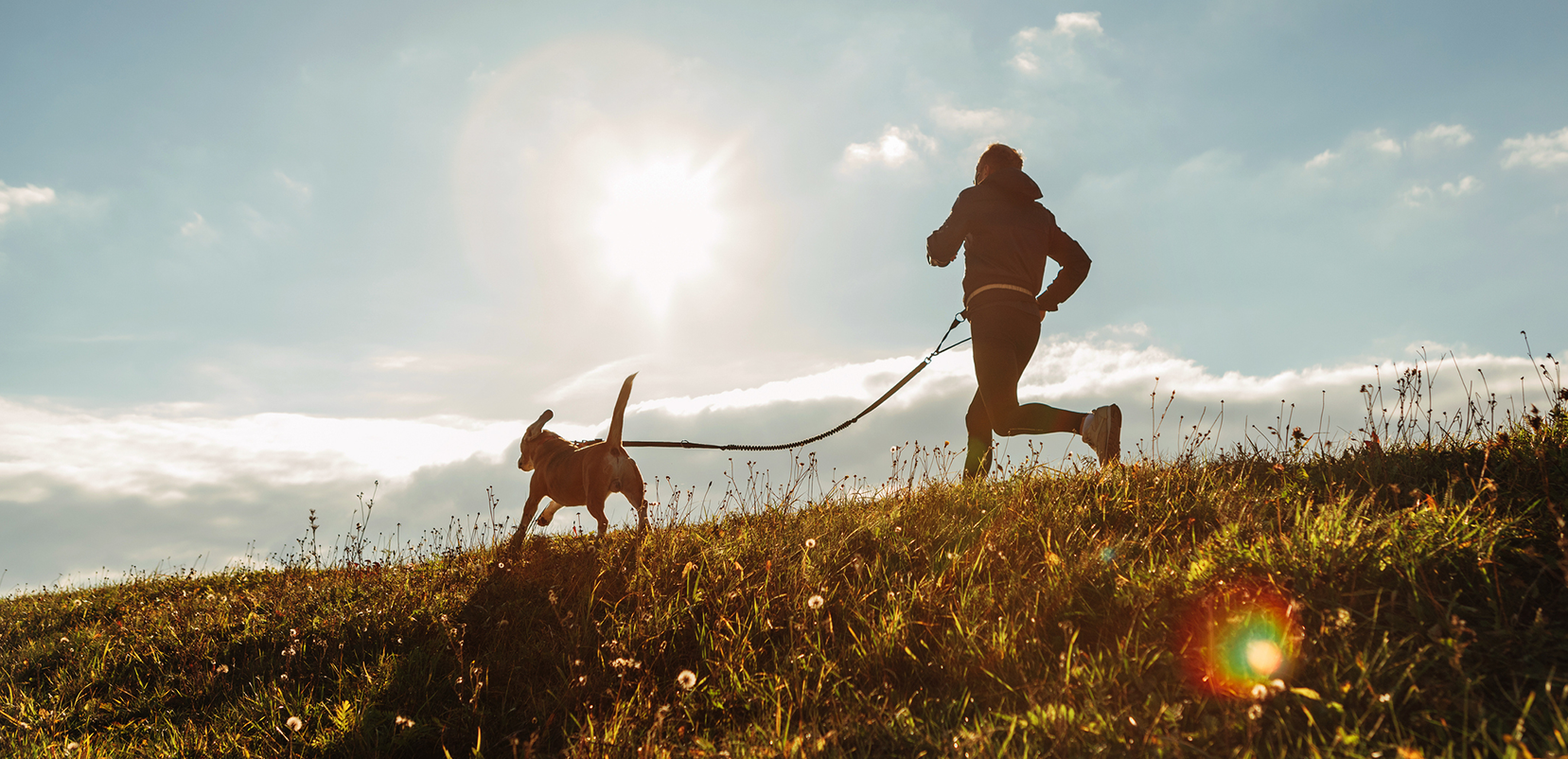 person running with dog