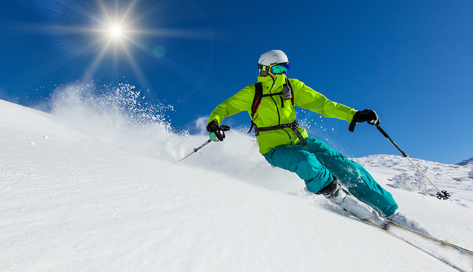 Downhill skier on sunny slope