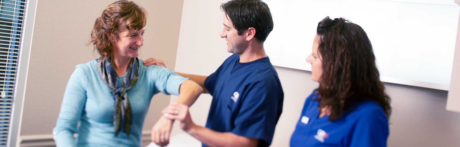 Dr. Dickens examining a patient's elbow