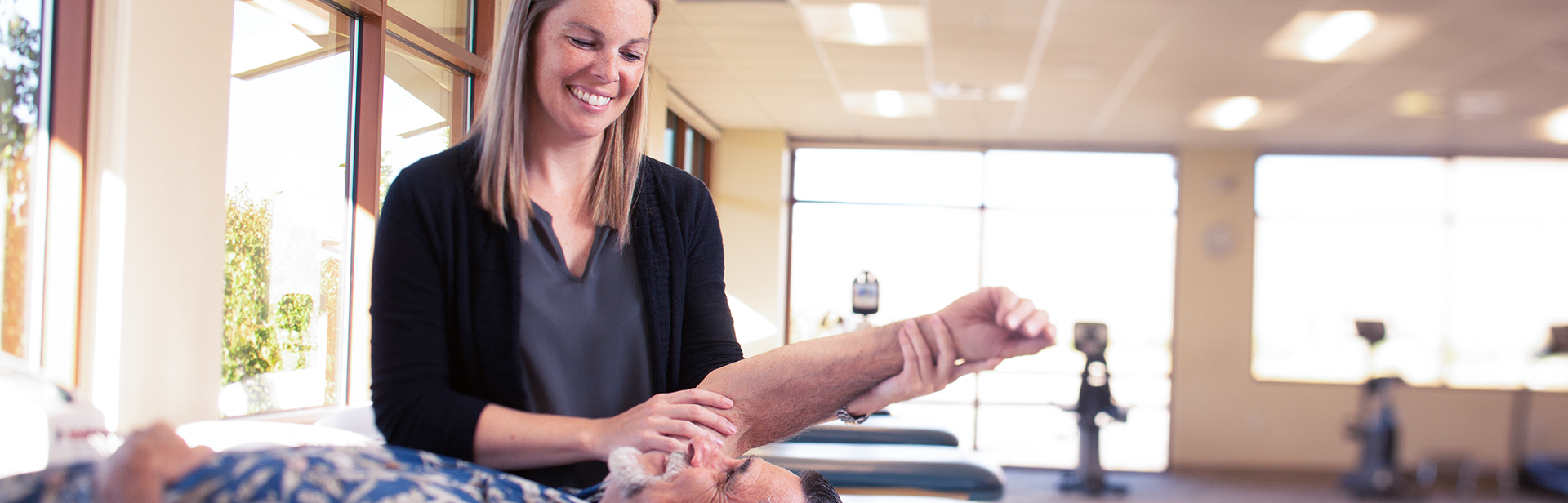 Physical therapist Amy Weyhenmeyer stretches a patient's shoulder 