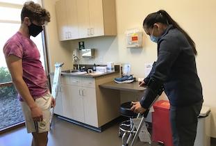Gio learns how to use crutches as he prepares for ankle surgery