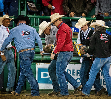 Dr Travis Kieckbusch and Justin Sports Medicine Team tending to rodeo participant