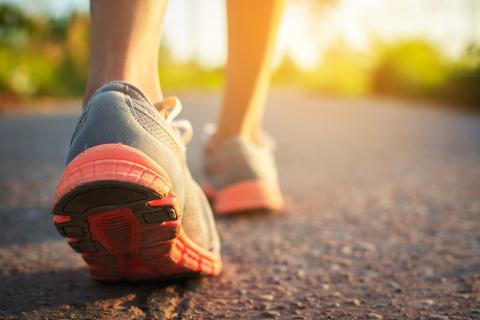 Image of person's feet walking down the street.