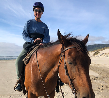 Marlies Radtke riding a horse on the beach