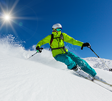 Downhill skier on sunny slope