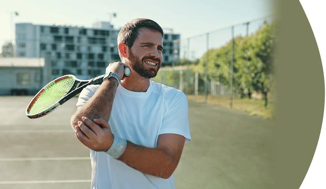 male tennis player holding painful elbow