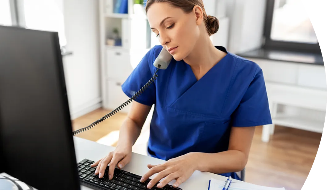 medical provider on the phone while typing