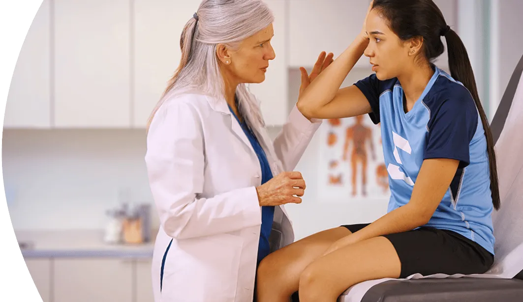 female doctor helping young athlete