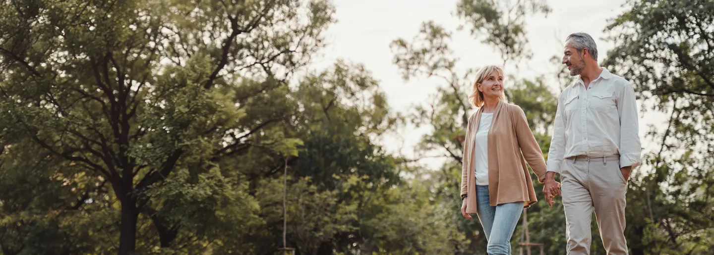 Photo of an older couple walking in the park