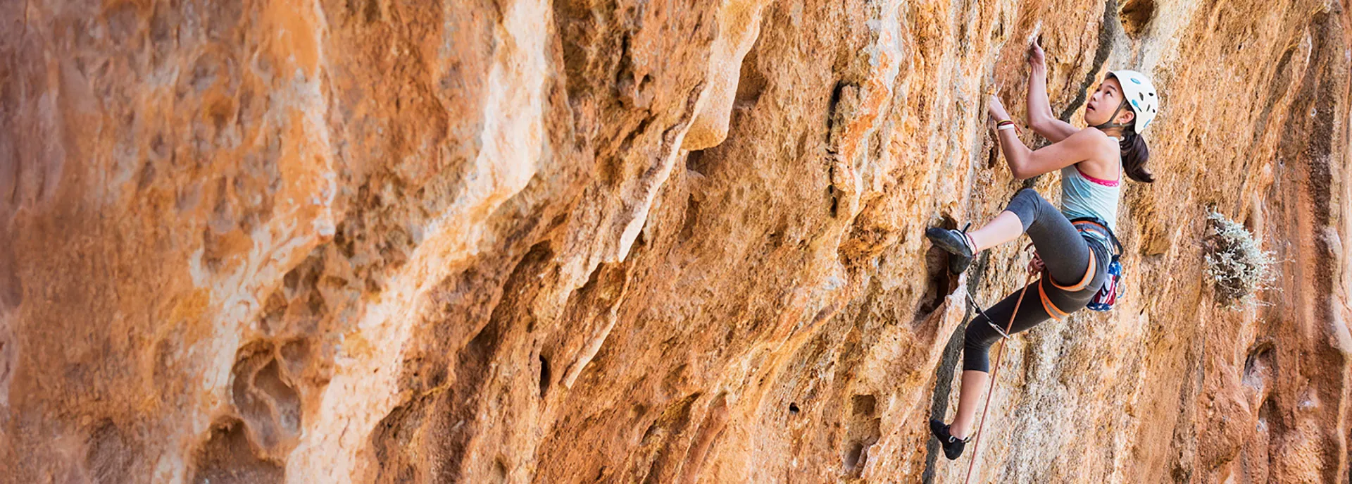 young woman rock climbing