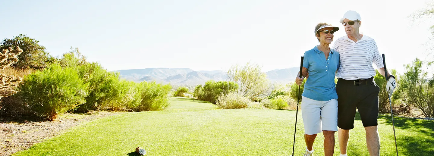 Photo of an older couple playing golf together