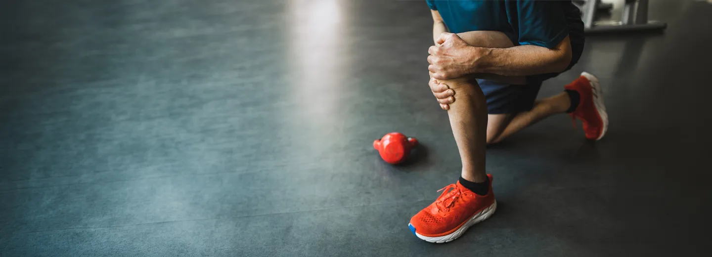 man holding knee in pain